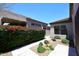 Well-maintained home exterior with lush red bougainvillea hedge and desert landscaping at 6939 E Bramble Berry Ln, Scottsdale, AZ 85266