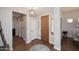 Inviting foyer with hardwood floors, wooden door and stylish light fixture at 6939 E Bramble Berry Ln, Scottsdale, AZ 85266