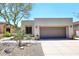 Inviting home featuring a two-car garage, neutral stucco, and desert landscaping at 6939 E Bramble Berry Ln, Scottsdale, AZ 85266