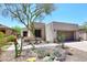 Charming home with rock landscaping, mature tree, and two-car garage at 6939 E Bramble Berry Ln, Scottsdale, AZ 85266