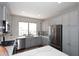 A bright open kitchen features gray cabinets, stainless appliances, and granite counters at 6939 E Bramble Berry Ln, Scottsdale, AZ 85266