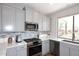 Bright kitchen features gray cabinetry, granite counters and stainless appliances at 6939 E Bramble Berry Ln, Scottsdale, AZ 85266