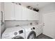 Well-equipped laundry room featuring a washer, dryer, and ample storage space at 6939 E Bramble Berry Ln, Scottsdale, AZ 85266