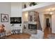Spacious living room featuring a stone fireplace and modern decor at 6939 E Bramble Berry Ln, Scottsdale, AZ 85266