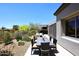 Outdoor dining area featuring a large table with cushioned chairs in a landscaped backyard at 6939 E Bramble Berry Ln, Scottsdale, AZ 85266