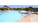 Community pool with multiple access points, seating, and sun umbrellas at 6939 E Bramble Berry Ln, Scottsdale, AZ 85266
