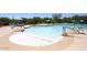 Community pool with various seating options, umbrellas, and easy access with handrails at 6939 E Bramble Berry Ln, Scottsdale, AZ 85266