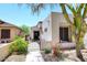 Side view of home showcasing a stone walkway leading to gated courtyard patio at 6939 E Bramble Berry Ln, Scottsdale, AZ 85266