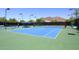 Community tennis court with mountain views, shaded seating, and well-lit courts at 6939 E Bramble Berry Ln, Scottsdale, AZ 85266