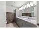 Contemporary bathroom features a double vanity with sleek gray cabinets, marble countertops, and modern lighting at 7141 E Rancho Vista Dr # 6007, Scottsdale, AZ 85251