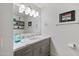 Contemporary bathroom with a large mirror, stylish lighting, and gray cabinets with marble countertop at 7141 E Rancho Vista Dr # 6007, Scottsdale, AZ 85251
