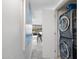 Convenient laundry room featuring stacked washer and dryer units, with a glimpse into the living area beyond at 7141 E Rancho Vista Dr # 6007, Scottsdale, AZ 85251