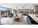 Bright living room with large windows offering beautiful views of the surrounding greenery and modern furniture at 7141 E Rancho Vista Dr # 6007, Scottsdale, AZ 85251