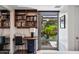 Well-organized office space with shelves, desk, and a window offering views of lush greenery, creating a serene workspace at 7141 E Rancho Vista Dr # 6007, Scottsdale, AZ 85251