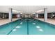 Indoor pool with lane markers and ample space for swimming and recreation under the bright lights of the ceiling at 7141 E Rancho Vista Dr # 6007, Scottsdale, AZ 85251