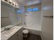 Clean bathroom with tiled shower/tub, window, and sleek vanity at 7905 W Thunderbird Rd # 305, Peoria, AZ 85381