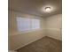 Cozy bedroom with neutral carpet, baseboards, and a window with blinds at 7905 W Thunderbird Rd # 305, Peoria, AZ 85381