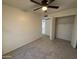 Bright bedroom featuring a ceiling fan, a closet and neutral-toned carpet at 7905 W Thunderbird Rd # 305, Peoria, AZ 85381