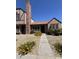 Charming townhome with manicured gravel yard, vibrant yellow flowers, and a brick chimney at 7905 W Thunderbird Rd # 305, Peoria, AZ 85381