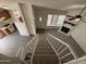 Open living space with a view of the kitchen, living room with fireplace, and staircase at 7905 W Thunderbird Rd # 305, Peoria, AZ 85381