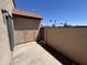 Private outdoor patio area with access to a gate and a small storage unit at 7905 W Thunderbird Rd # 305, Peoria, AZ 85381