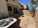 Backyard with patio, adjacent building with sliding glass door, and an air conditioner at 7905 W Thunderbird Rd # 307, Peoria, AZ 85381
