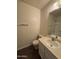 Standard bathroom with a sink, toilet, mirror, and towel rack for essential functionality at 7905 W Thunderbird Rd # 307, Peoria, AZ 85381