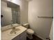Standard bathroom with a white sink, toilet, mirror, and towel rack for essential functionality at 7905 W Thunderbird Rd # 307, Peoria, AZ 85381
