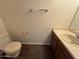 Bathroom features a toilet, laminate floors, neutral wall color, vanity and mirror at 7905 W Thunderbird Rd # 307, Peoria, AZ 85381