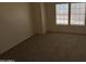 A carpeted bedroom with natural light streaming through two windows, creating a cozy atmosphere at 7905 W Thunderbird Rd # 307, Peoria, AZ 85381