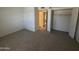 Bedroom featuring neutral carpet, an open closet, and access to hallways at 7905 W Thunderbird Rd # 307, Peoria, AZ 85381