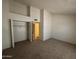 Bright, carpeted bedroom features a closet and neutral paint, creating a blank canvas at 7905 W Thunderbird Rd # 307, Peoria, AZ 85381