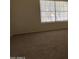 Spacious bedroom with neutral carpet and a large window providing natural light at 7905 W Thunderbird Rd # 307, Peoria, AZ 85381