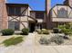 Charming townhome featuring a front yard with lush greenery and brick accents at 7905 W Thunderbird Rd # 307, Peoria, AZ 85381