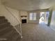Open living room space featuring a cozy fireplace and stairs to the upper level at 7905 W Thunderbird Rd # 307, Peoria, AZ 85381