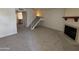 Inviting living room featuring plush carpet flooring and fireplace, with stairs to upper level at 7905 W Thunderbird Rd # 307, Peoria, AZ 85381