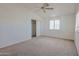 Spacious bedroom with a ceiling fan, closet, and windows dressed with shutters at 9043 N 14Th Dr, Phoenix, AZ 85021
