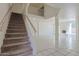 Home foyer with tiled flooring and a carpeted staircase at 9043 N 14Th Dr, Phoenix, AZ 85021