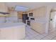 Kitchen featuring white cabinets, countertops, and a breakfast bar at 9043 N 14Th Dr, Phoenix, AZ 85021