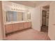 Bathroom featuring a long vanity with dual mirrors and a walk-in closet at 9043 N 14Th Dr, Phoenix, AZ 85021