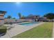 Community pool with green lawn and lounge chairs, ideal for relaxation and summer fun at 9043 N 14Th Dr, Phoenix, AZ 85021