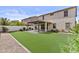 This backyard boasts a covered patio and artificial turf, perfect for outdoor entertaining and minimal maintenance at 9727 E Torino Ave, Mesa, AZ 85212