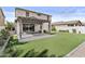 Backyard with artificial turf, pergola, and sliding glass doors at 9727 E Torino Ave, Mesa, AZ 85212