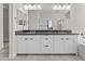 Bathroom featuring double sinks with framed mirrors and ample cabinet storage at 9727 E Torino Ave, Mesa, AZ 85212