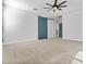 Spacious bedroom features a barn-style door and ceiling fan at 9727 E Torino Ave, Mesa, AZ 85212