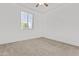 Bedroom with neutral carpeting, window with blinds, ceiling fan, and fresh paint at 9727 E Torino Ave, Mesa, AZ 85212