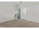 A neutral bedroom featuring updated baseboards and doors to hall and closet at 9727 E Torino Ave, Mesa, AZ 85212