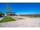 Bocce ball court near community center with view of parking, landscaping, and tennis courts at 9727 E Torino Ave, Mesa, AZ 85212
