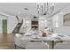 Open-concept dining room boasts a marble table, adjacent to staircase and fireplace at 9727 E Torino Ave, Mesa, AZ 85212