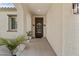 Inviting entrance featuring an arched entryway, elegant light fixtures and potted plants at 9727 E Torino Ave, Mesa, AZ 85212